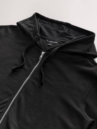 Zip-up hoodie manufacturer inspecting zipper alignment and premium hoodie quality